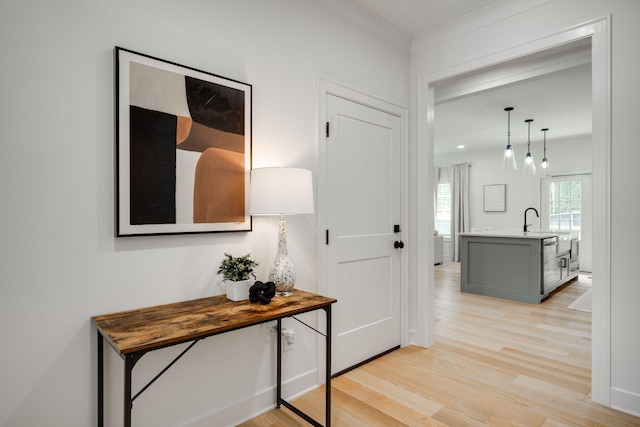 hallway with light hardwood / wood-style floors