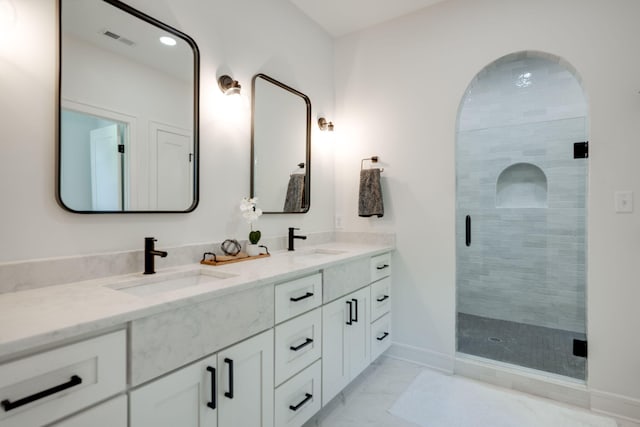 bathroom with tile patterned floors, vanity, and an enclosed shower