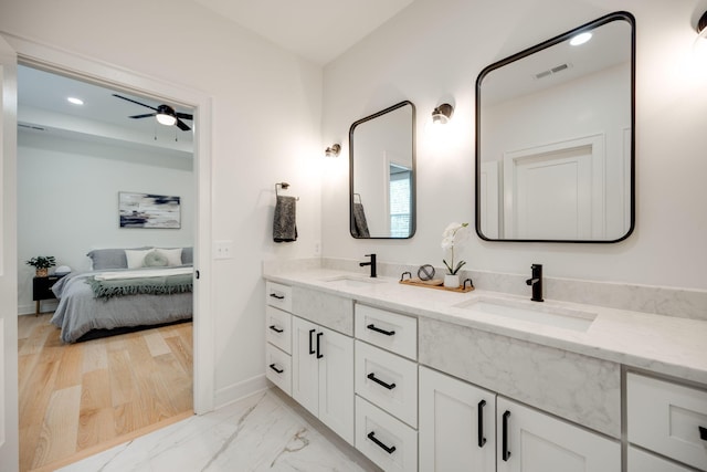 bathroom with wood-type flooring, vanity, and ceiling fan