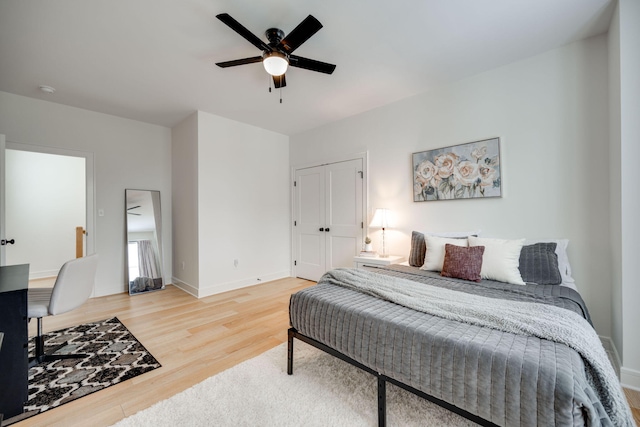 bedroom featuring hardwood / wood-style floors, a closet, and ceiling fan