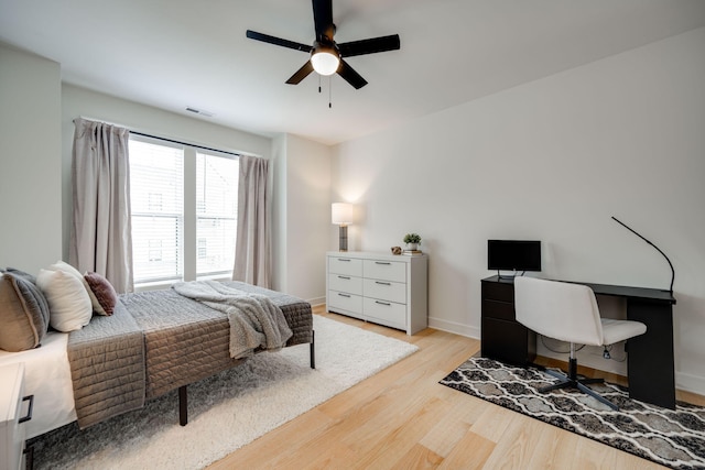 bedroom with light hardwood / wood-style flooring and ceiling fan