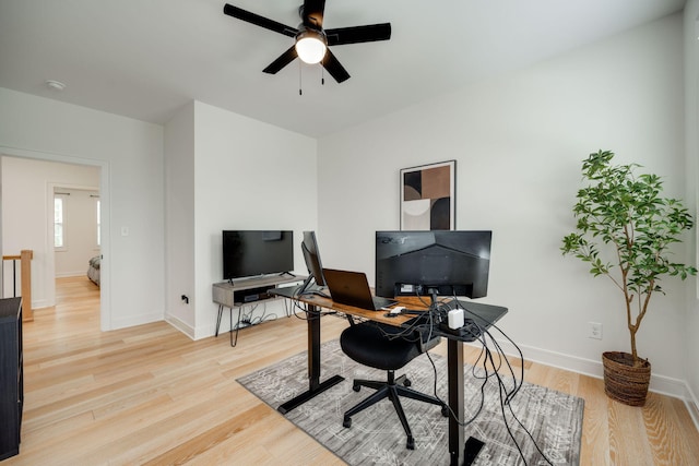 office space with light wood-type flooring and ceiling fan