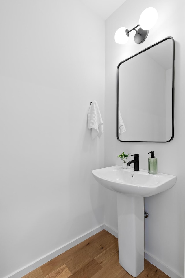 bathroom with wood-type flooring and sink