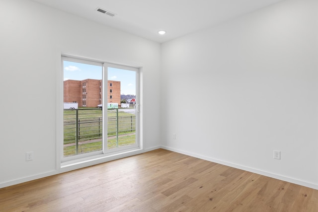 unfurnished room with light hardwood / wood-style flooring