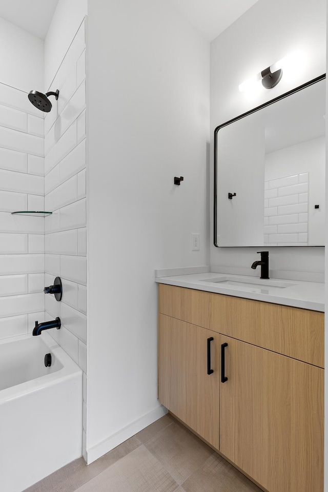 bathroom featuring vanity and tiled shower / bath