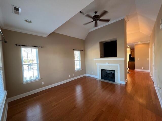 unfurnished living room featuring a tile fireplace, ceiling fan, wood-type flooring, and ornamental molding