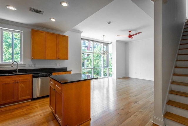 kitchen featuring ceiling fan, sink, light hardwood / wood-style flooring, stainless steel dishwasher, and a kitchen island