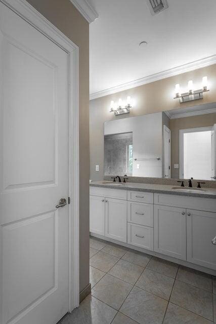 bathroom featuring crown molding, tile patterned flooring, and vanity