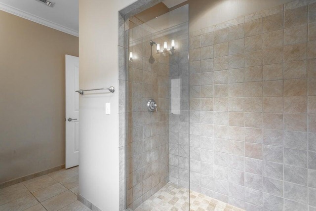 bathroom with tile patterned floors, ornamental molding, and tiled shower