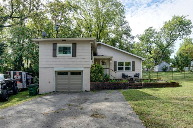 view of front of property with a front lawn and a garage