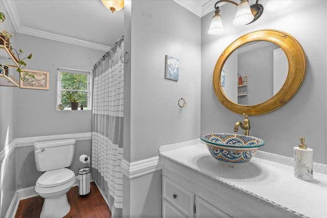 bathroom with hardwood / wood-style floors, vanity, toilet, and crown molding