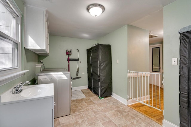 clothes washing area featuring sink and plenty of natural light