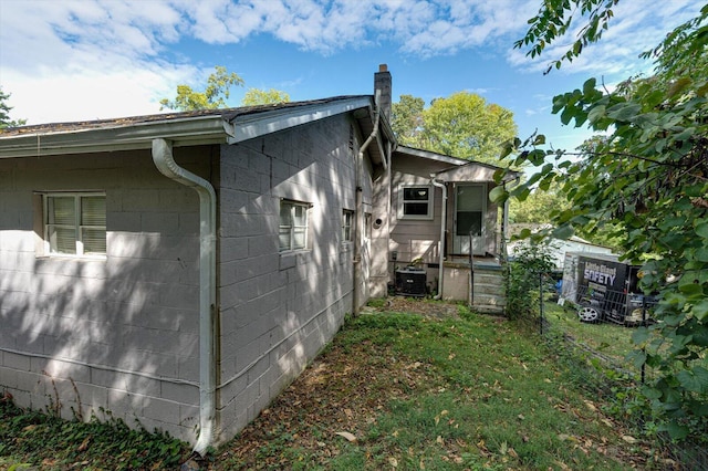 view of side of home featuring central AC