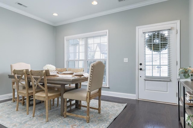 dining area featuring a healthy amount of sunlight, crown molding, and dark wood-type flooring