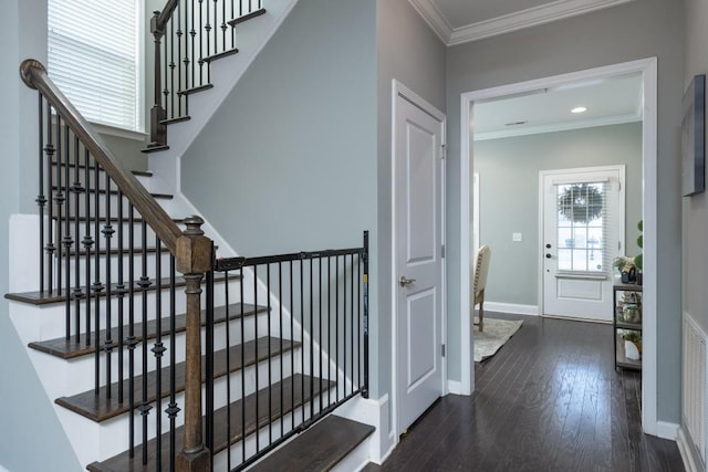 staircase with hardwood / wood-style flooring and ornamental molding