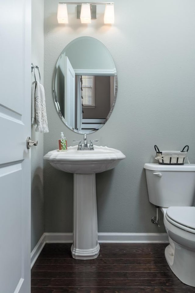 bathroom featuring hardwood / wood-style floors and toilet