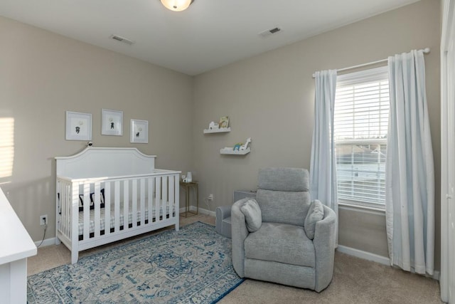 carpeted bedroom with a nursery area