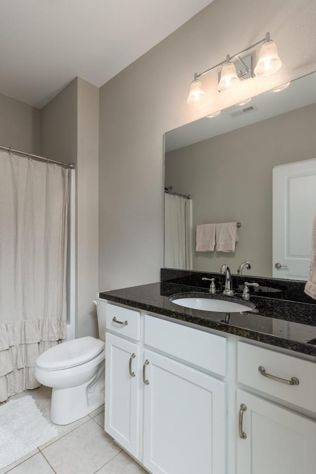 bathroom with tile patterned flooring, vanity, toilet, and a shower with shower curtain