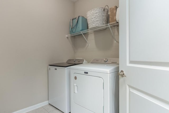 laundry area with light tile patterned flooring and independent washer and dryer