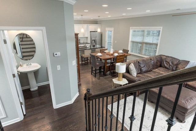 living room featuring dark hardwood / wood-style flooring and ornamental molding