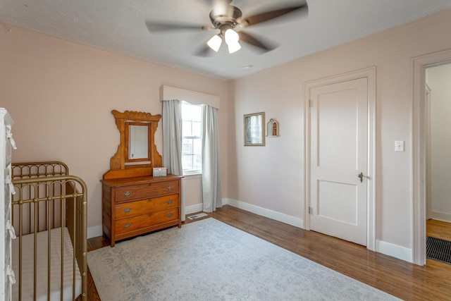 bedroom featuring hardwood / wood-style flooring and ceiling fan