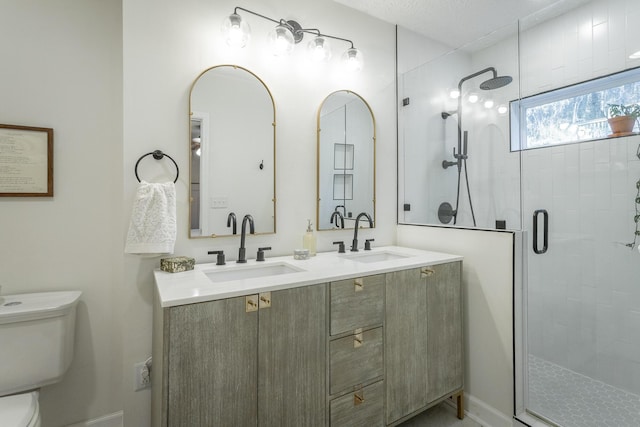 bathroom featuring an enclosed shower, vanity, and toilet