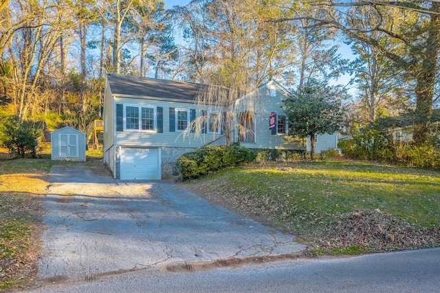 view of front of house with a front yard, a shed, and a garage