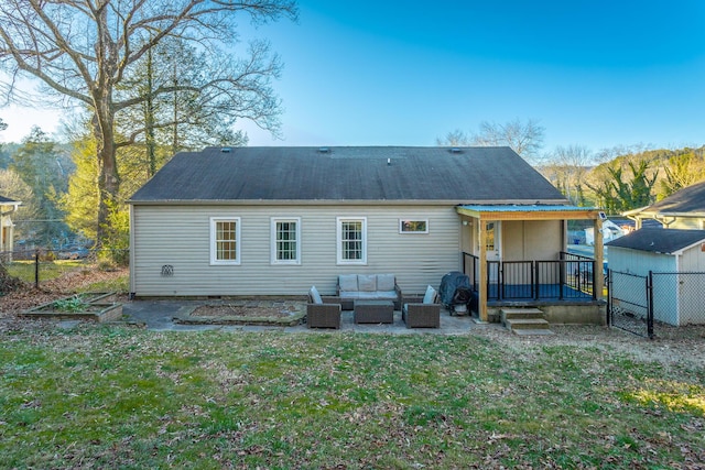 back of property with outdoor lounge area, a yard, and a patio