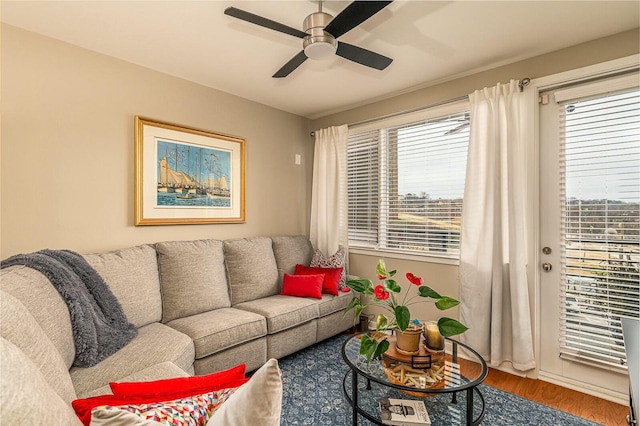 living room with wood-type flooring and ceiling fan