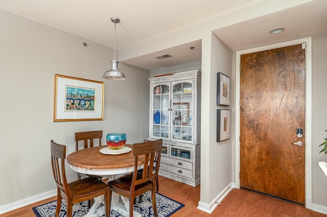 dining area with hardwood / wood-style floors