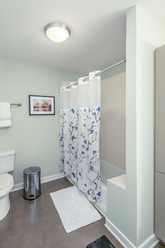 bathroom featuring tile patterned flooring, toilet, and shower / bath combo