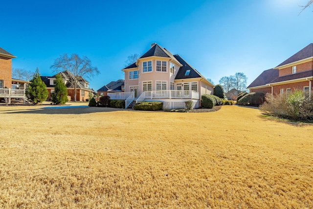 rear view of house with a yard