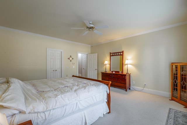 carpeted bedroom featuring a closet, ceiling fan, and ornamental molding