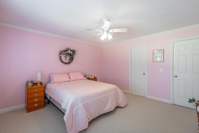 carpeted bedroom featuring ceiling fan and crown molding