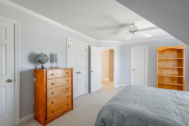 bedroom featuring ceiling fan, crown molding, light colored carpet, and a textured ceiling