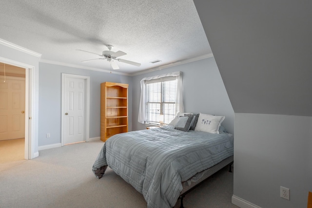 bedroom featuring a textured ceiling, light colored carpet, ceiling fan, and ornamental molding