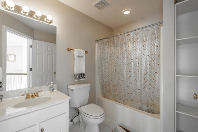 full bathroom featuring a textured ceiling, vanity, shower / bath combo with shower curtain, tile patterned flooring, and toilet