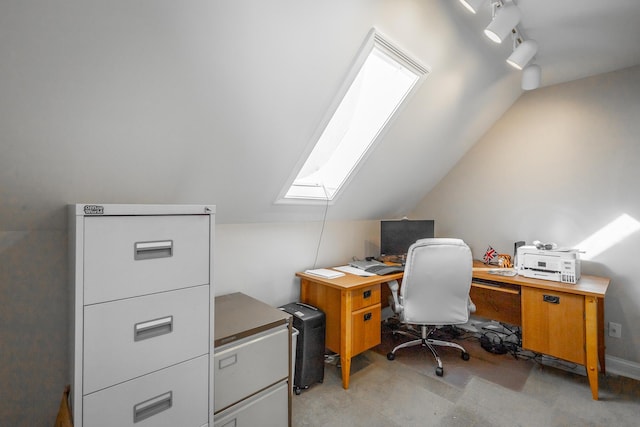 office space with vaulted ceiling with skylight