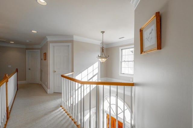 corridor featuring light colored carpet and ornamental molding