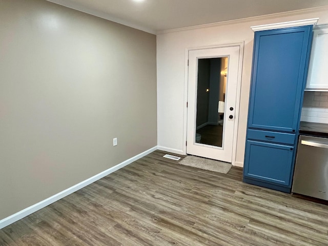 unfurnished room featuring dark wood-type flooring and ornamental molding