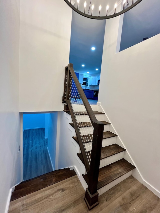 stairs with hardwood / wood-style flooring