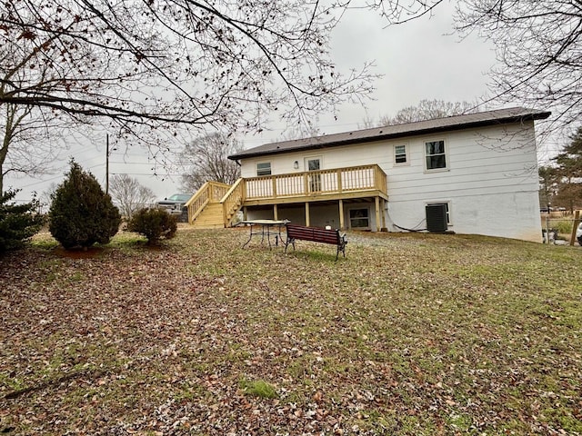 rear view of property with a yard and a deck