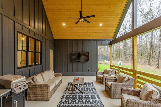 sunroom with vaulted ceiling, ceiling fan, and wooden ceiling