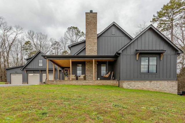 modern farmhouse style home featuring a front yard, a porch, and a garage