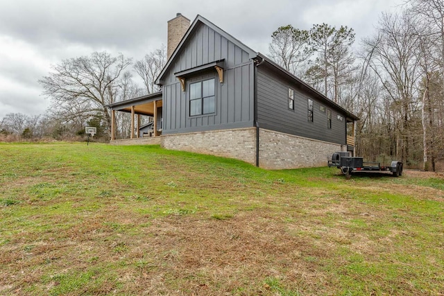 view of side of property with a lawn