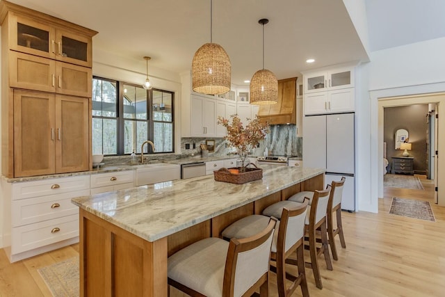 kitchen featuring a kitchen island, white cabinetry, and stainless steel appliances