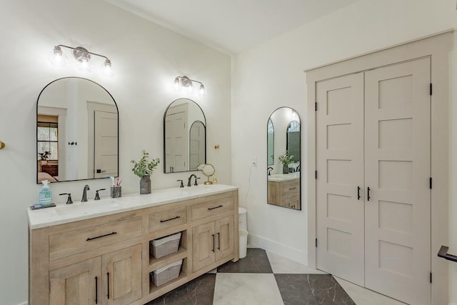 bathroom featuring tile patterned flooring and vanity