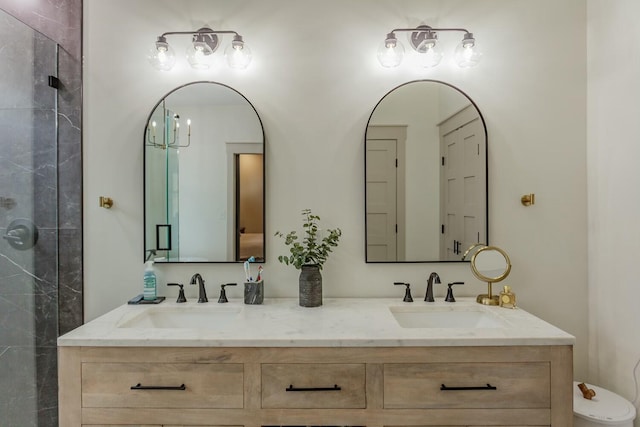 bathroom with vanity, a shower with shower door, and a notable chandelier