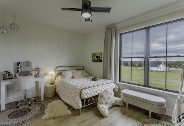 bedroom featuring light hardwood / wood-style floors and ceiling fan