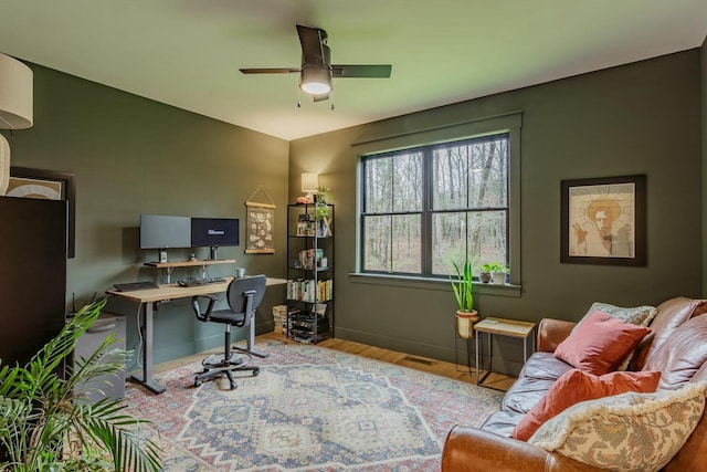 office with ceiling fan and light hardwood / wood-style flooring